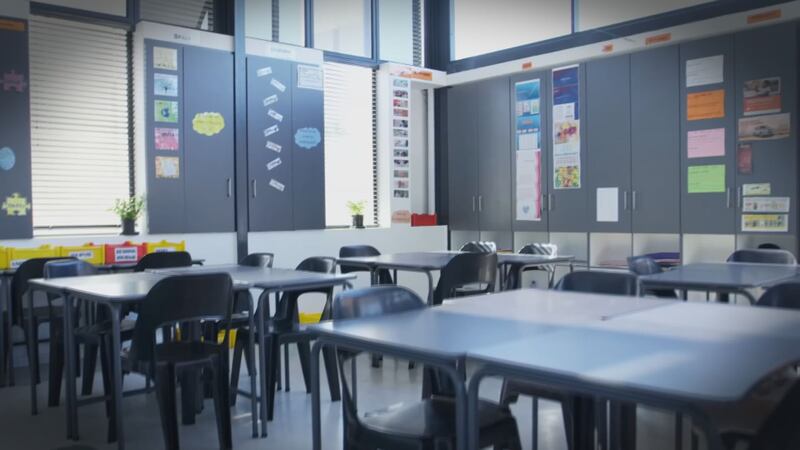 Generic school classroom with empty chairs.